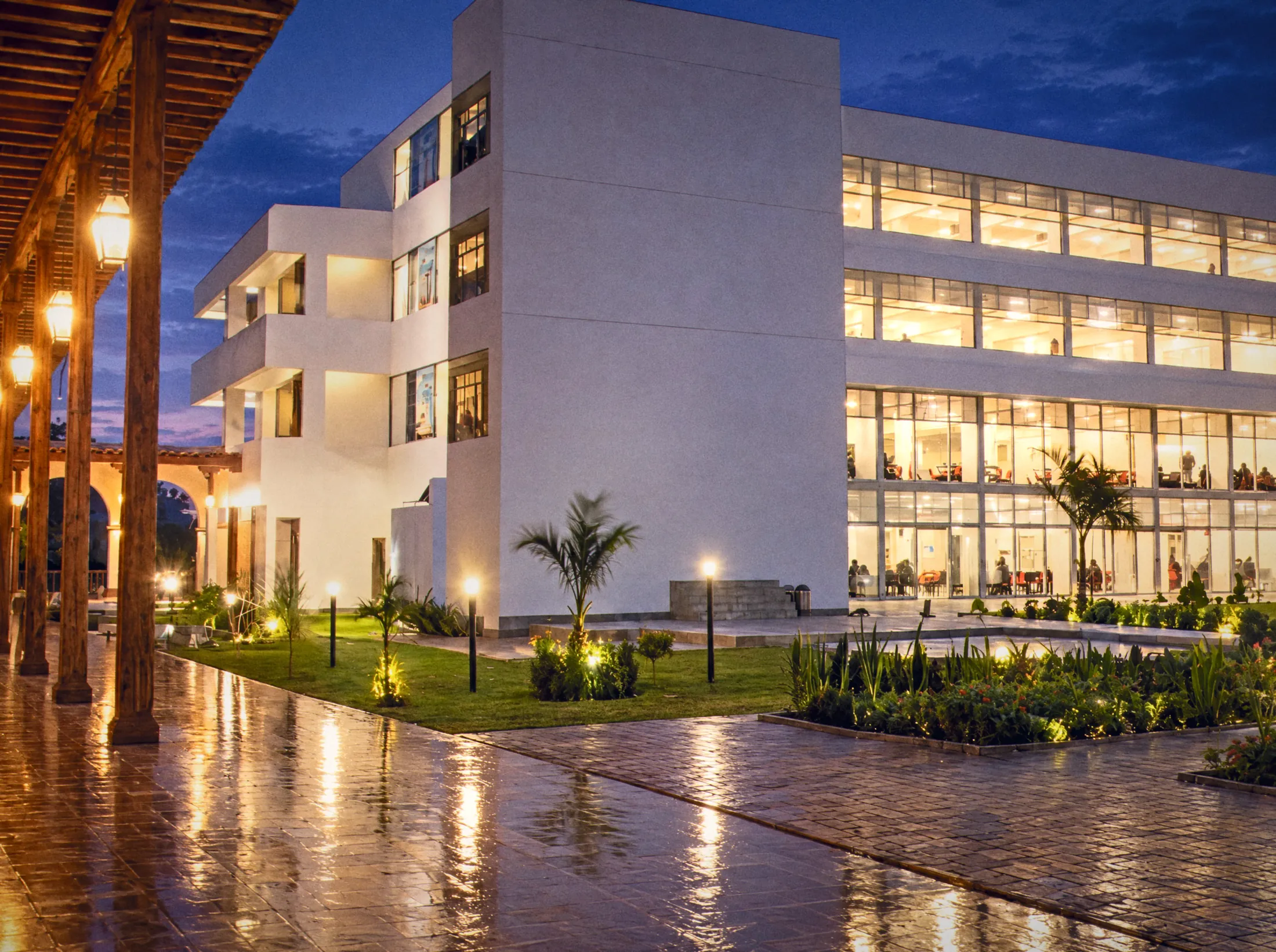 University campus at dusk with a lit courtyard